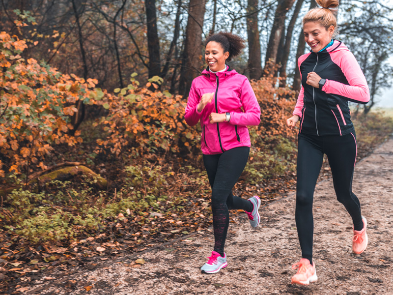 Photo of two women jogging on a nature trail at Cedar Creek