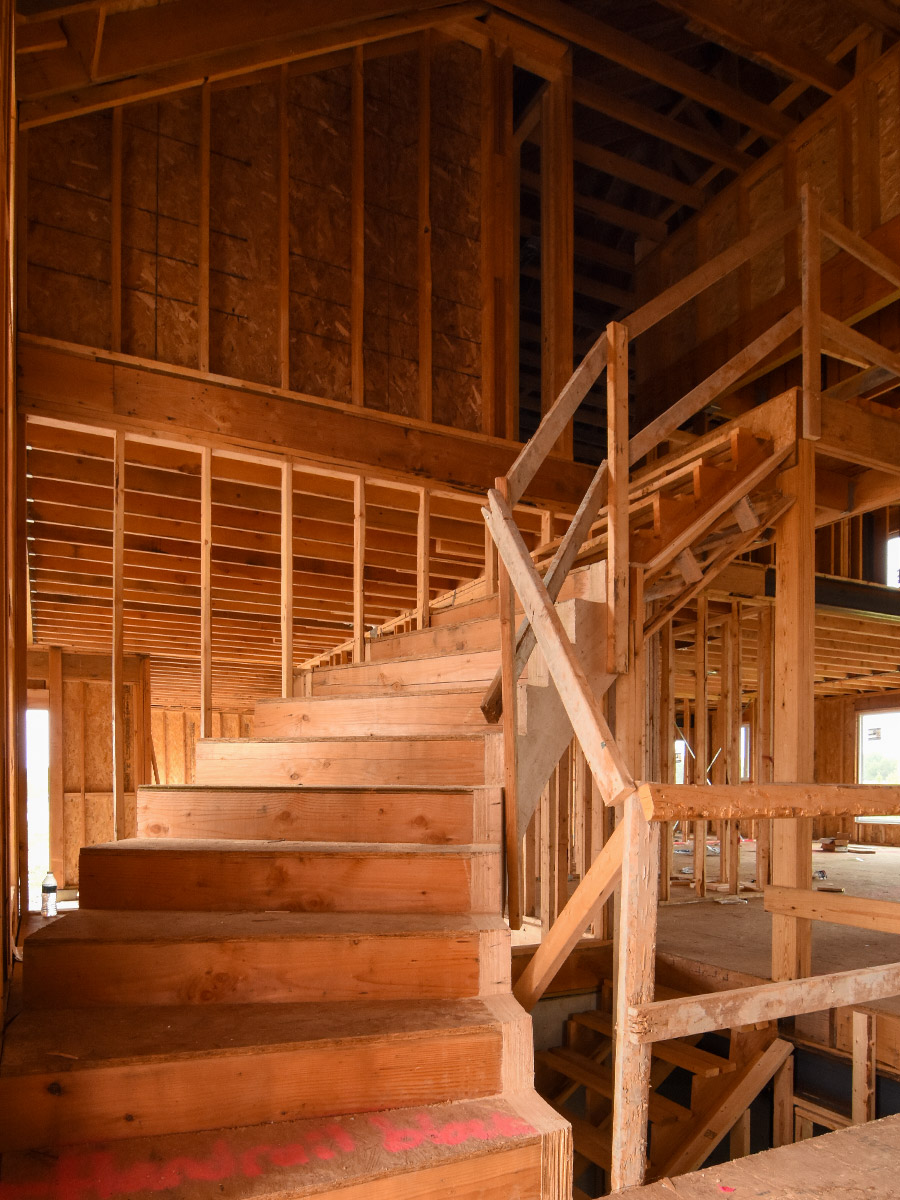 curved staircase in the framing phase inside a new house under construction